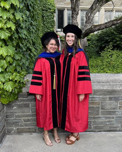 Two Cornell PhD graduates in regalia 