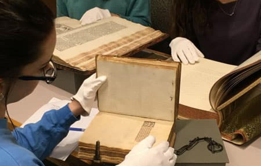 Students studying medieval manuscripts