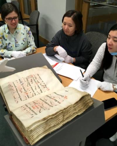 Students studying medieval manuscripts